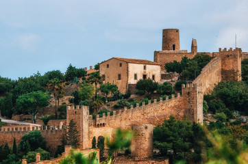 Capdepera castle on green hill in Mallorca island, Spain. Beautiful landscape with medieval architecture in Majorca