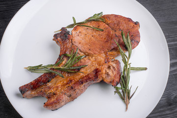 steak pork on a plate with rosemary