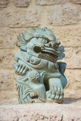 Closeup shot of a Chinese guardian lion sculpture made of stone. 