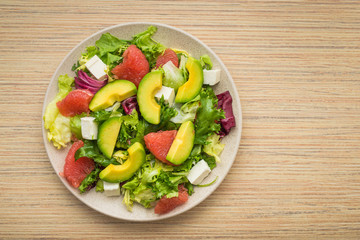 Fresh salad with avocado and fruits