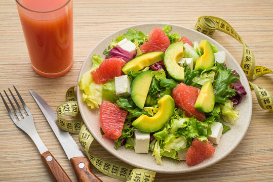 Fresh salad with avocado and fruits