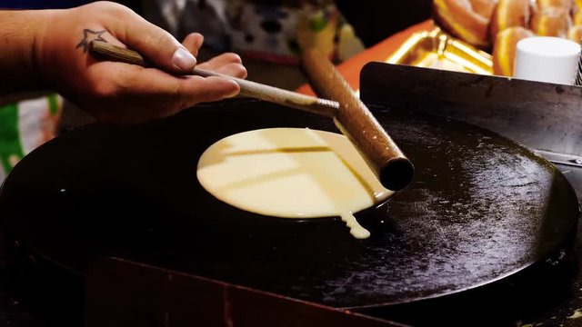 cooking the crepes: put dough on the hot plate