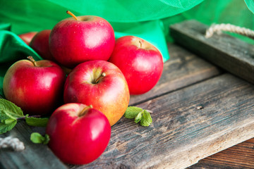 ripe red apples on wooden background