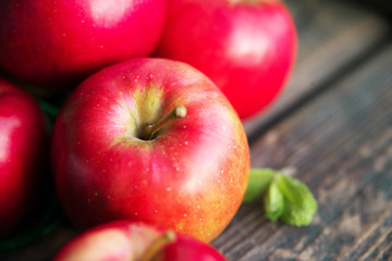 group of red apples on wooden natural background, fresh natural food and vitamins concept in rustic style