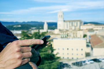 young man using his smartphone in Girona, Spain