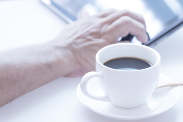Cup of coffee and modern touch screen notebook.