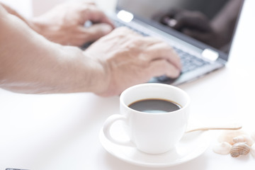 Cup of coffee and modern touch screen notebook.
