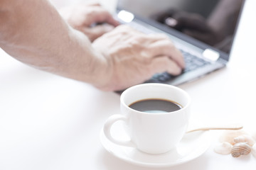 Cup of coffee and modern touch screen notebook.