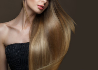 Beautiful blond girl with a perfectly smooth hair, classic make-up. Beauty face. Picture taken in the studio on a white background.