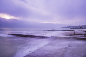 Early morning on the seashore. Stone piers and shore, long exposure. Quiet beautiful sea landscape.

