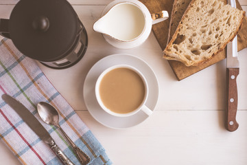 Obraz na płótnie Canvas Fast breakfast, coffee with milk and fresh pastries, French press - top view