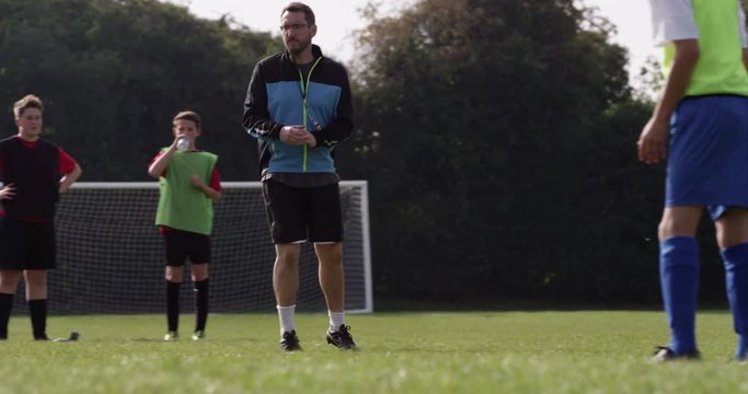 Soccer coach psyching up a young player during training session.Shot on RED Epic
