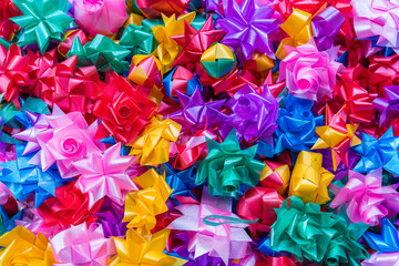 Colorful ribbon flowers for giving alms to make merit in Thai's religious traditional