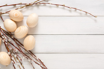 Wooden easter eggs on white wood background