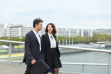 economists walk during lunch break, married American middle-aged couple going to have snack. Man...