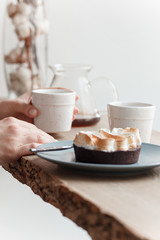 Cup of coffee, branch of tree, wooden windowsill