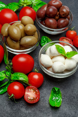 Traditional Italian products - Mozzarella cheese, basil, tomato and olives