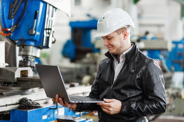 young engineer with laptop in hands