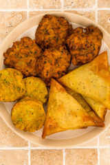 Selection of Indian Snacks Vegetarian Onion Bhaji Samosas and Tikka