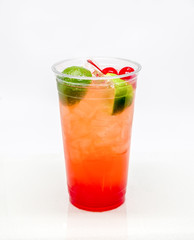 Fresh Squeezed Cherry Limeade in a clear plastic cup on a white background.