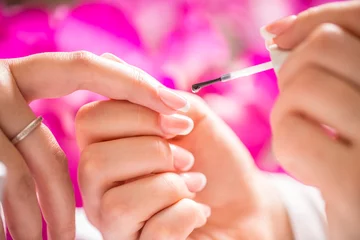Fotobehang Manicure specialist painting woman gel nail. Art - French manicure © weyo