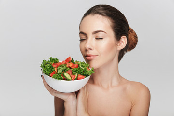 attractive young woman with bowl of healthy salad isolated on white