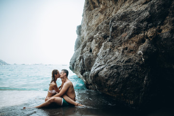 Couple kiss and hug in the sea. Love story. Italy