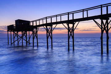 Fototapeta premium Beautiful view of fishing huts at sunset over the Atlantic Ocean