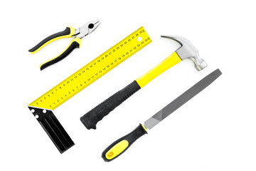Repair tool kit. File, hummer, corner ruler, pilers on white background top view pattern