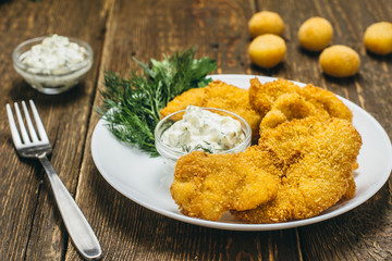Chicken fillet in batter, cheese balls in batter, with sauce and dill
