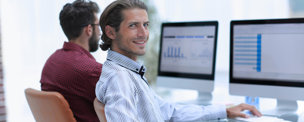 business partners are working on the computer