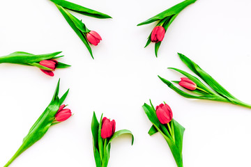 Bright red tulips for spring bouquet on white background top view copy space