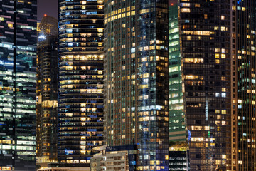 Fototapeta na wymiar Scenic glowing windows of skyscrapers at evening