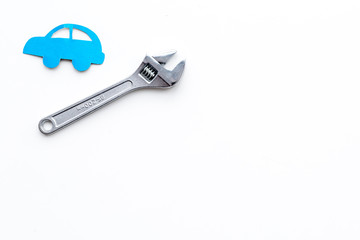 Car failures. Car service concept. Car silhouette and wrench on white backgound top view copy space