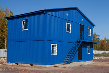 Blue mobile building in industrial site or office container in construction site.