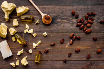Homemade soap with cocoa butter. Cosmetics with natural ingredient. Dark wooden background top view