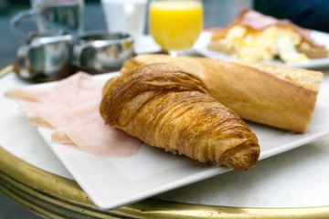 Breakfast with coffee and croissants on table