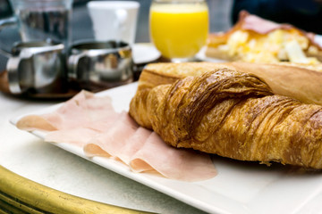 Breakfast with coffee and croissants on table