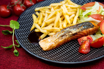 Grilled Salmon with fresh lettuce and Golden French fries