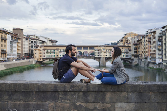 Couple at sunset in front of Ponte Vecchio, Florence