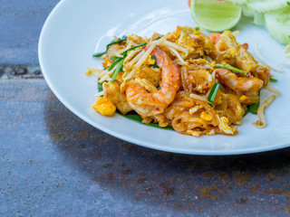 Pad thai with prawn serve in white plate with vegetable