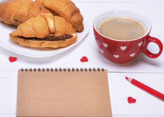 empty notebook, red cup with coffee