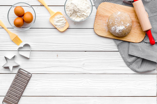 Make dough. Ingedients flour, eggs near cookware on white wooden background top view copy space