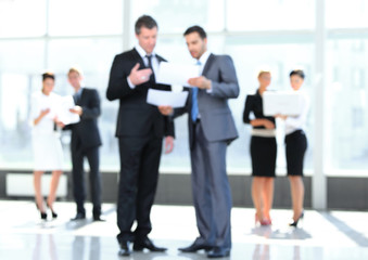 image is blurred. business partners discuss the working papers.