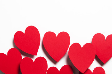 Red handmade paper hearts on a white background