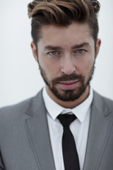 Serious businessman wearing suit and tie. blue background