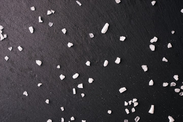 White crystals sea salt on a black background