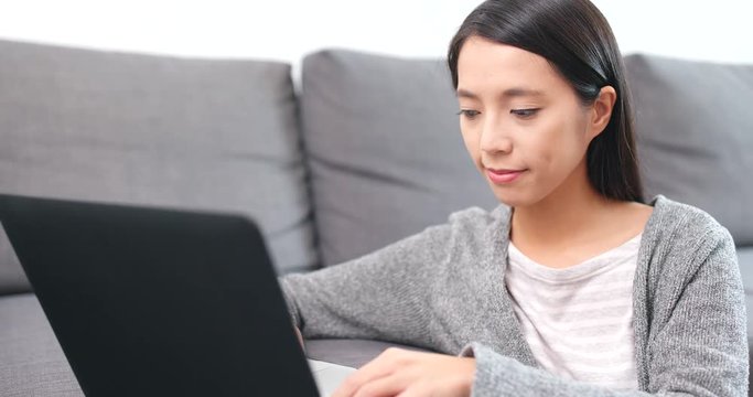 Woman working on notebook computer at home
