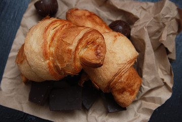 Close up of Croissant or Rolls Over Brown Craft Paper, overhead view. Breakfast Food.