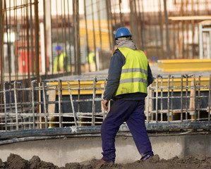 Fototapeta na wymiar Slacker is walking with cigarettes through the construction site